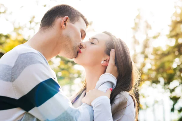 Felice giovane coppia innamorata baciarsi. Parcheggiare all'aperto data. Amare coppia relazione . — Foto Stock