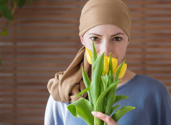 Young Positive Adult Female Cancer Patient Holding Bouquet Yellow Tulips — Stock Photo, Image