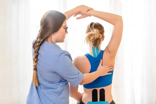 Young Female Patient Wearing Kinesio Tape Her Back Neck Exercising — Stok fotoğraf