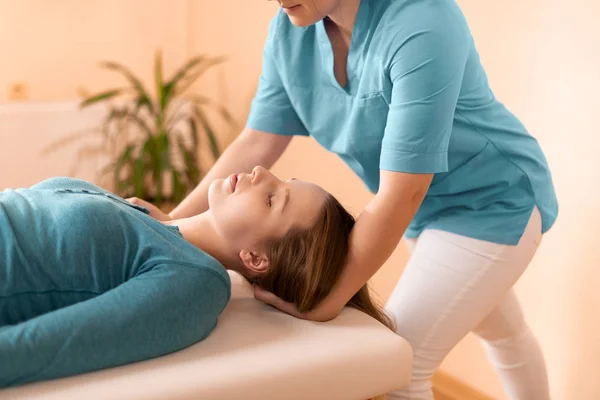 Female Physiotherapist Chiropractor Adjusting Patients Neck Physiotherapy Rehabilitation Concept Side — Stok fotoğraf