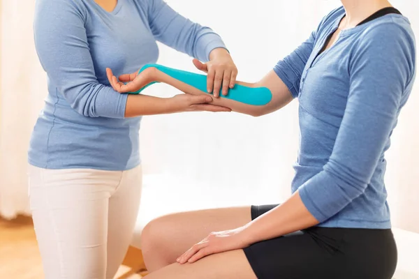 Female Physiotherapist Applying Kinesio Tape Patient Arm Kinesiology Physical Therapy — 스톡 사진