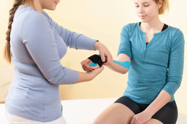 Female Physiotherapist Applying Kinesio Tape Patient Arm Kinesiology Physical Therapy — 스톡 사진