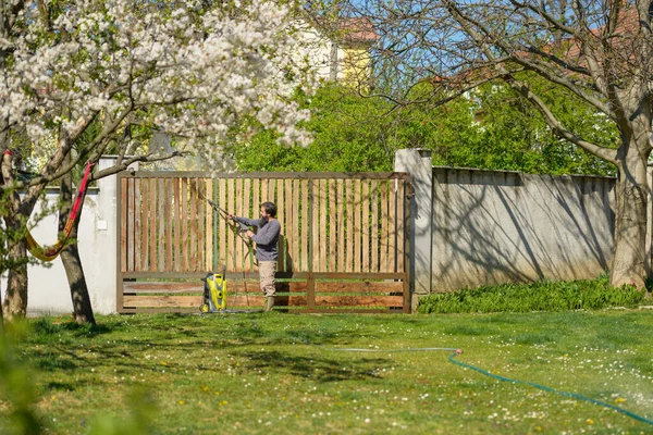 Yetişkin Bir Adam Tahta Kapıyı Elektrikli Makineyle Temizliyor Bahçe Kapısının — Stok fotoğraf