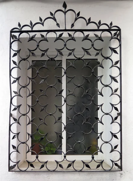 Decorative iron grill over residential window — Stock Photo, Image