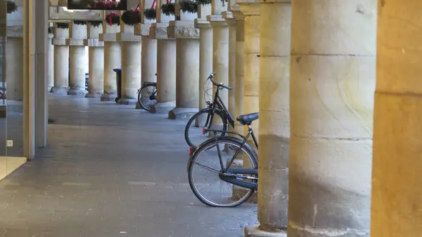 parked bicycles against columns