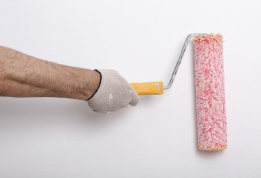 Bir duvar boya silindiri ile boyama ressam kolu yakın çekim