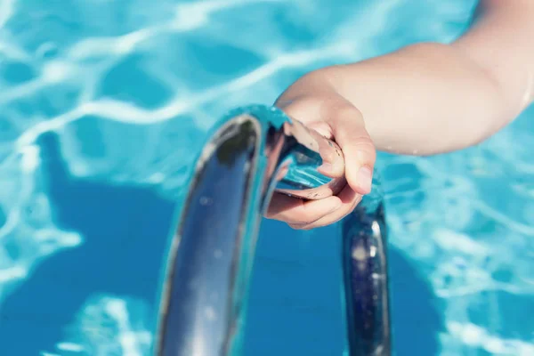 Una mano che tiene un corrimano in una piscina — Foto Stock