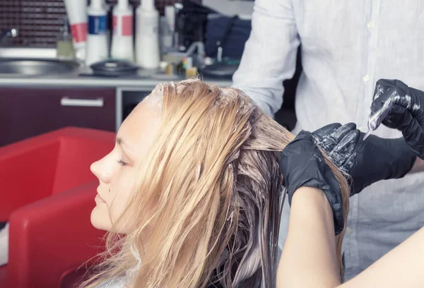 Eine blonde Kundin färbt Haare im Friseursalon — Stockfoto