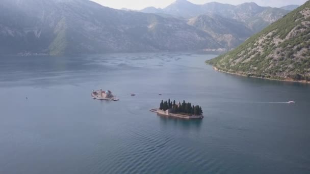 Aerial footage of St. George and monastery on the islands near Perast town in Kotor bay — Stock Video