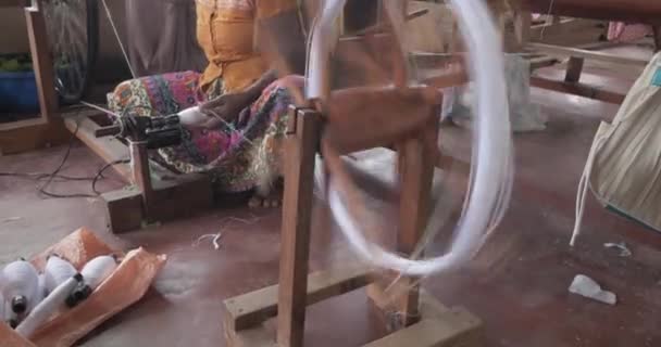 Hands of an old woman using an old spinning wheel to turn wool into yarn — 图库视频影像