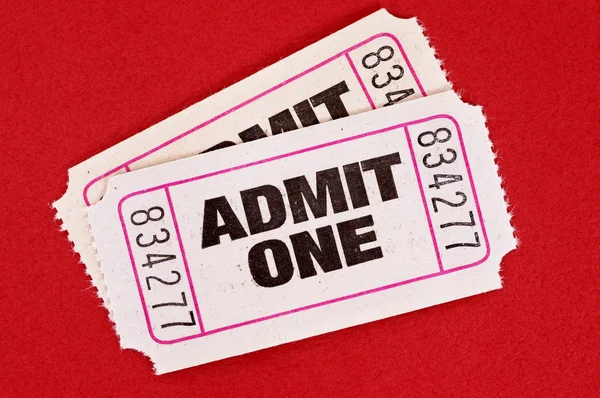 Two white admit one movie tickets on a red background. — Stock Photo, Image