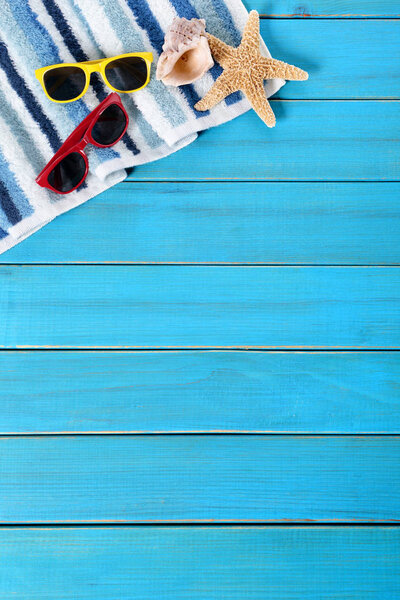 Summer beach background border, sunglasses, towel, starfish, blu