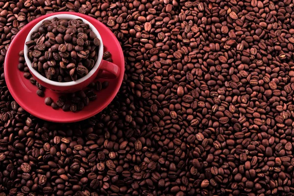 Красная чашка кофе с жареными бобами — стоковое фото