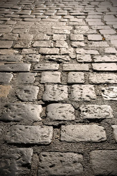 Close up di vecchio ciottolo pietra strada superficie sfondo texture — Foto Stock