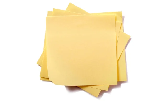 Untidy stack yellow sticky post notes isolated on white — Stock Photo, Image