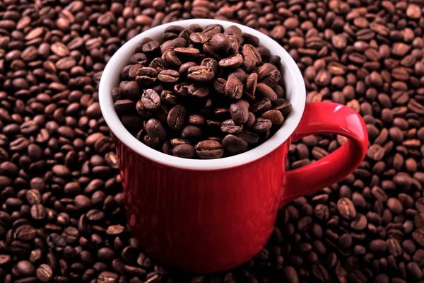 Red coffee mug filled with beans