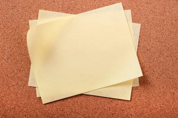 Pile several untidy yellow post notes cork notice board — Stock Photo, Image