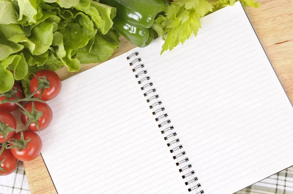 Salad with blank recipe book and chopping board — Stock Photo, Image