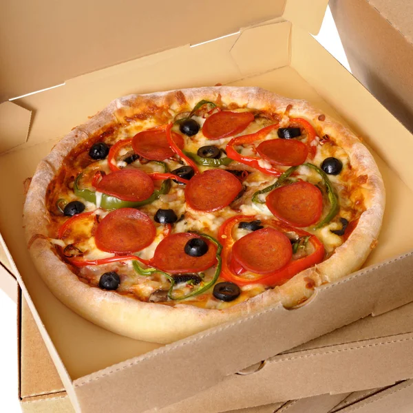 Freshly baked Pizza with stack of delivery boxes Royalty Free Stock Photos