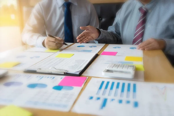 businessman working on paper to proof maket plan