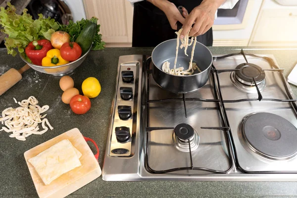 chef home made do pasta soba noodle in the kitchen with green vegetable tomato sweet pepper