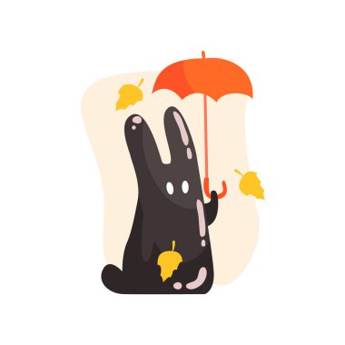 Siyah zift jöle tavşan turuncu şemsiye altında düşen sarı yapraklar, açık havada sonbahar sezonunda tutan canavar şekil