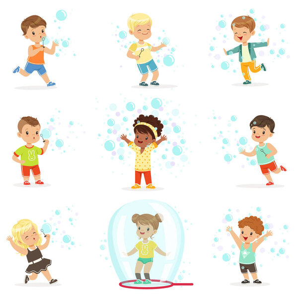 Cute little girls and boys blowing and playing soap bubbles