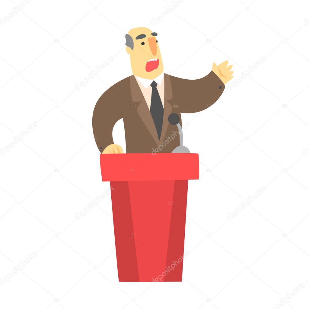 A man public speaking behind a red tribune in a brown suit