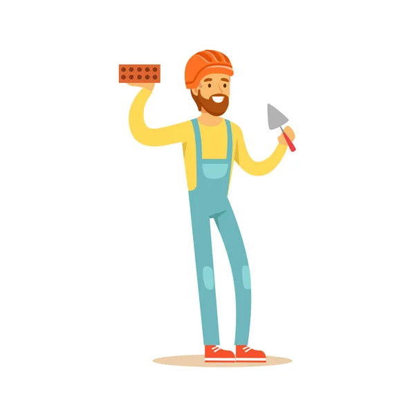 Smiling bricklayer wearing orange safety helmet and work clothes standing and holding brick and trowel in his hands, colorful character vector Illustration — Stock Vector