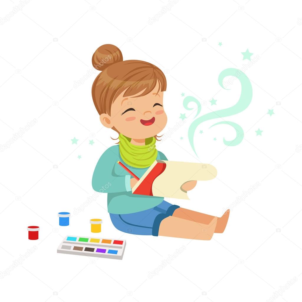 girl drawing with paints in her notebook