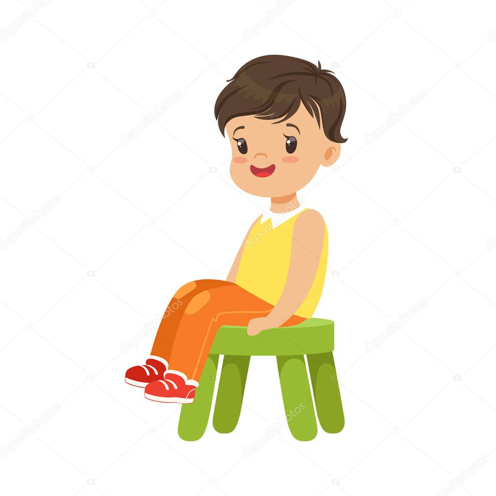 boy sitting on a small green stool