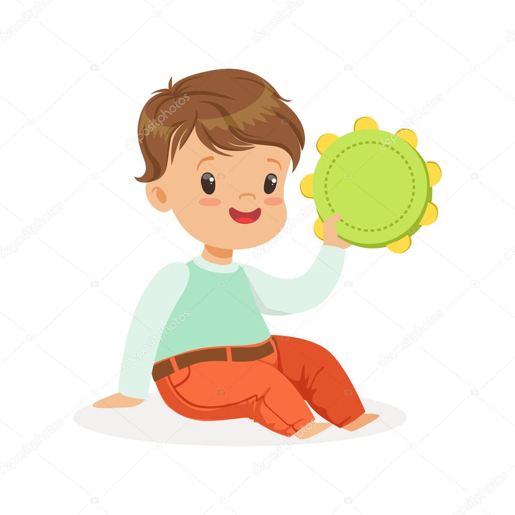 Cute little boy playing tambourine