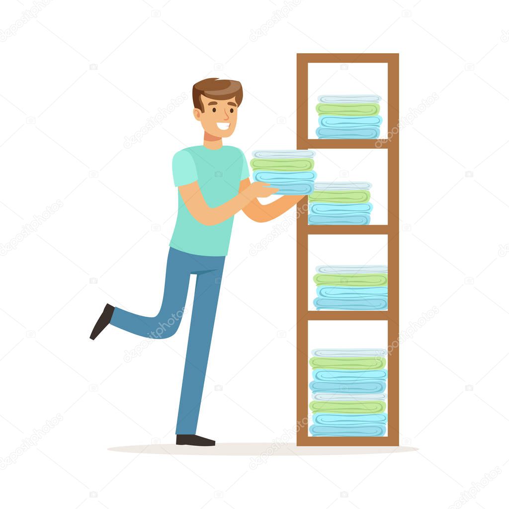 Young smiling man putting linen on shelves, house husband working at home vector Illustration