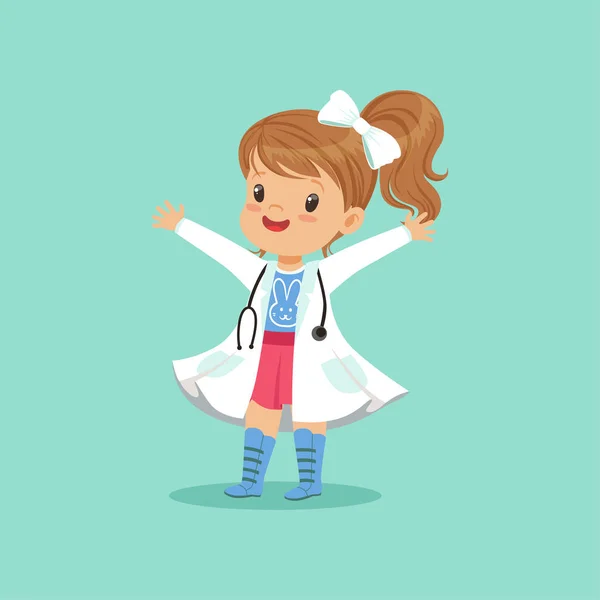 Cheerful baby girl in white coat and stethoscope around her neck standing with hands up isolated on blue background. Child playing doctor game — Stock Vector