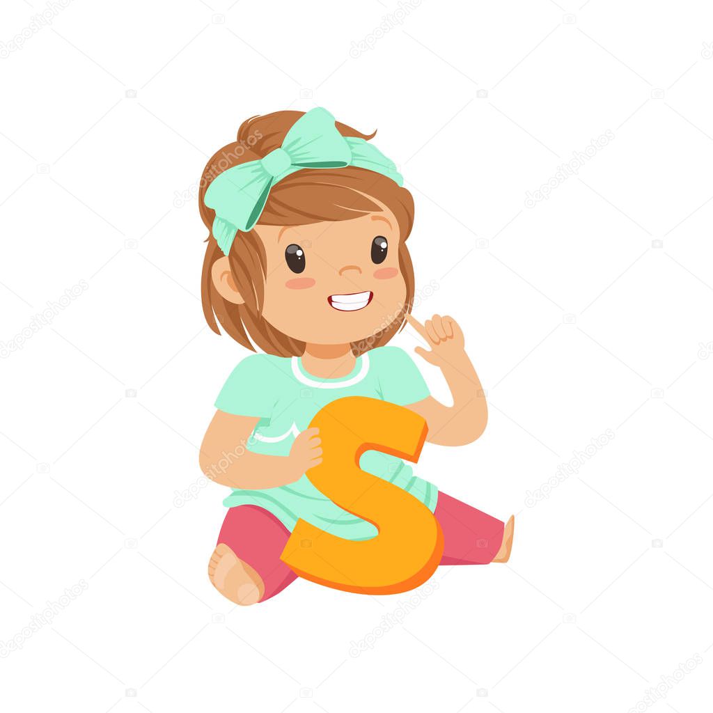 Adorable toddler girl sitting on the floor and learning correctly pronounce letter S. Education and children development concept