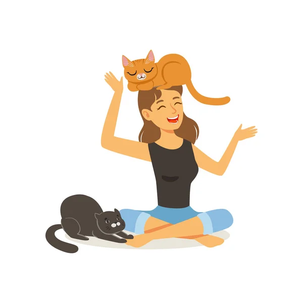 Lachen jonge vrouw zitten met de benen gekruist. Rode kat op meisje s hoofd, zwarte kat naast gastvrouw. Vrouwelijke personage plezier met kittens. Huisdier. Platte vector — Stockvector