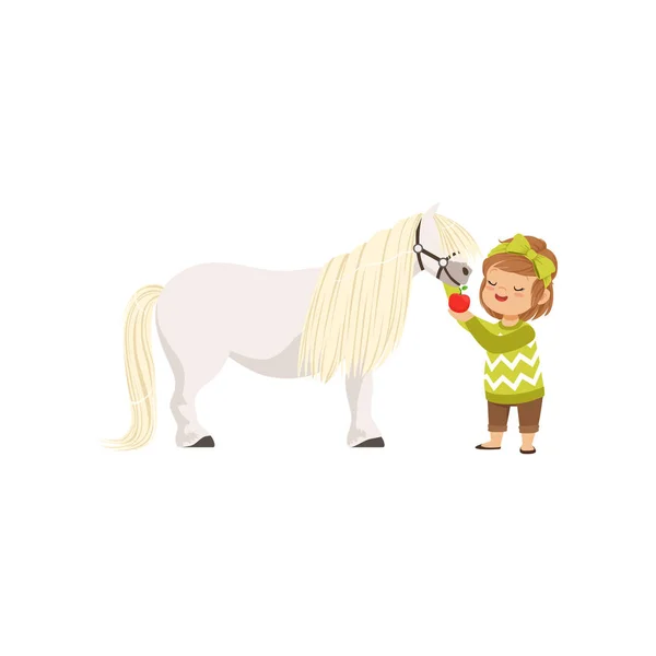 Härlig liten flicka att ta hand om hennes ponny häst mata den med rött äpple, barn att ta hand om hennes djur vektor Illustration — Stock vektor