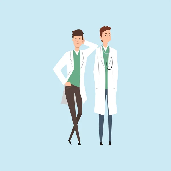 Två leende läkare tecken, medicinsk personal vektor illustrationen på en ljusblå bakgrund — Stock vektor