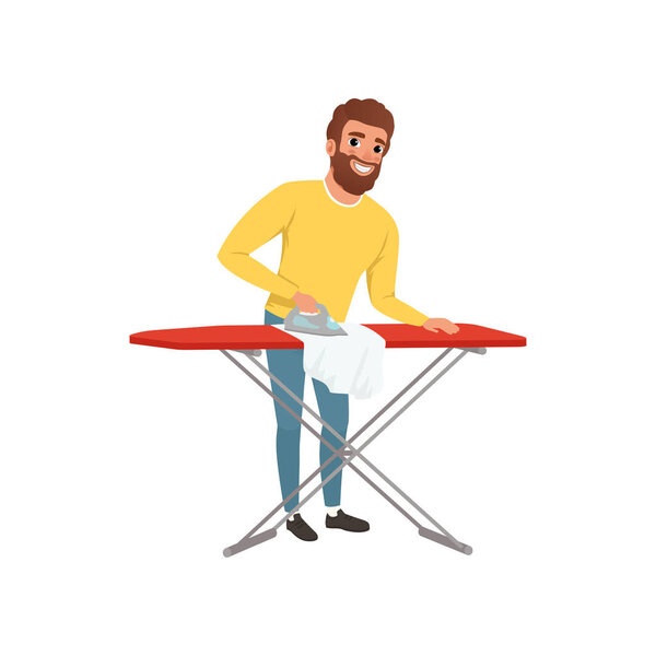 Улыбающийся мужчина гладит одежду на гладильной доске. Мультяшный муж. Молодой парень в жёлтом свитере и синих джинсах. Тема домашнего хозяйства. Плоский векторный дизайн
