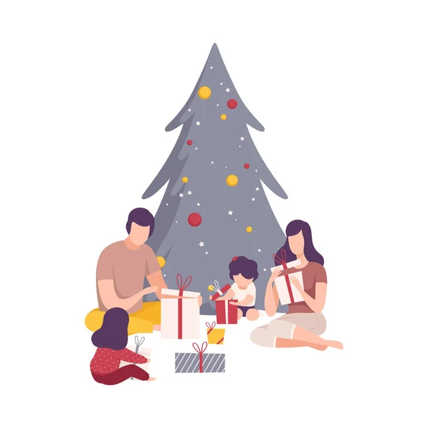 Οικογένεια κάθεται κάτω από το χριστουγεννιάτικο δέντρο Ξετυλίγοντας κουτιά δώρων Vector Εικονογράφηση — Διανυσματικό Αρχείο