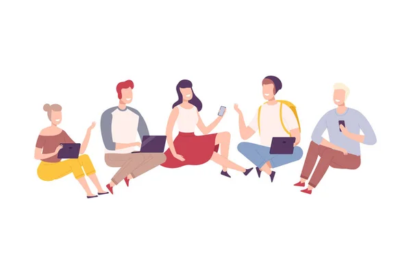 Group of People with Modern Digital Gadgets, Cheerful Young Men and Women Sitting on the Floor and Communicating People with Smartphone, Tablet, Laptop Flat Vector Illustration — Stock Vector