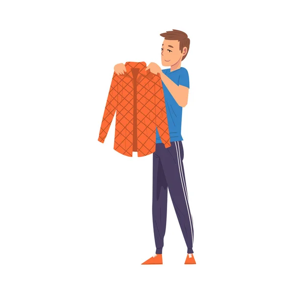 Man Folding Clothes, Household Activity, Housekeeping, Everyday Duties and Chores Cartoon Vector Illustration — Stock Vector