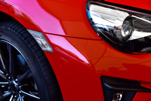 Detail of red sport classic car. Headlight lamp