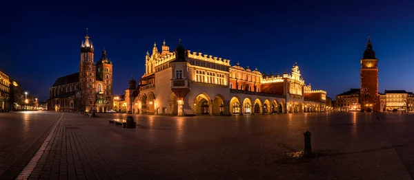 Cloth Hall Sukiennice building and main square of the old town illuminated at night on main square of Cracow. Poland  Panoramic view