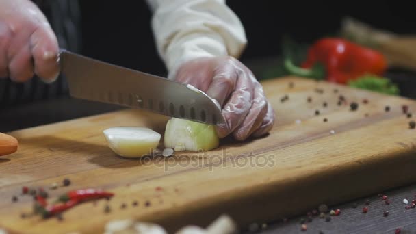 El chef corta cebolla. Cebollas como ingrediente para hacer sopa u otro plato. Vista superior cámara lenta — Vídeos de Stock