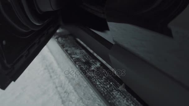 Close-up person in black rock shoes getting out of car — Stock Video