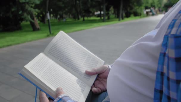 Nahaufnahme eines älteren Mannes, der im Park liest — Stockvideo