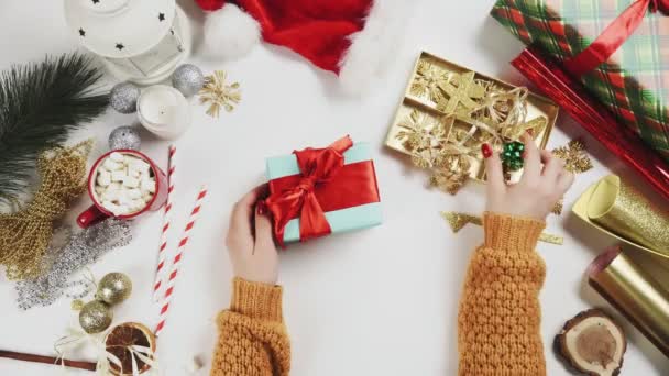 Mujer envolviendo regalo de Navidad y la decoración es por estrella de madera — Vídeos de Stock