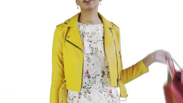 Portrait of african american woman with shopping bags and GOLD credit card on white Background in Studio. Yellow jacket — Stock Video