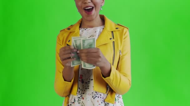 Attractive Afro american woman is counting money against a green background Yellow jacket — 비디오